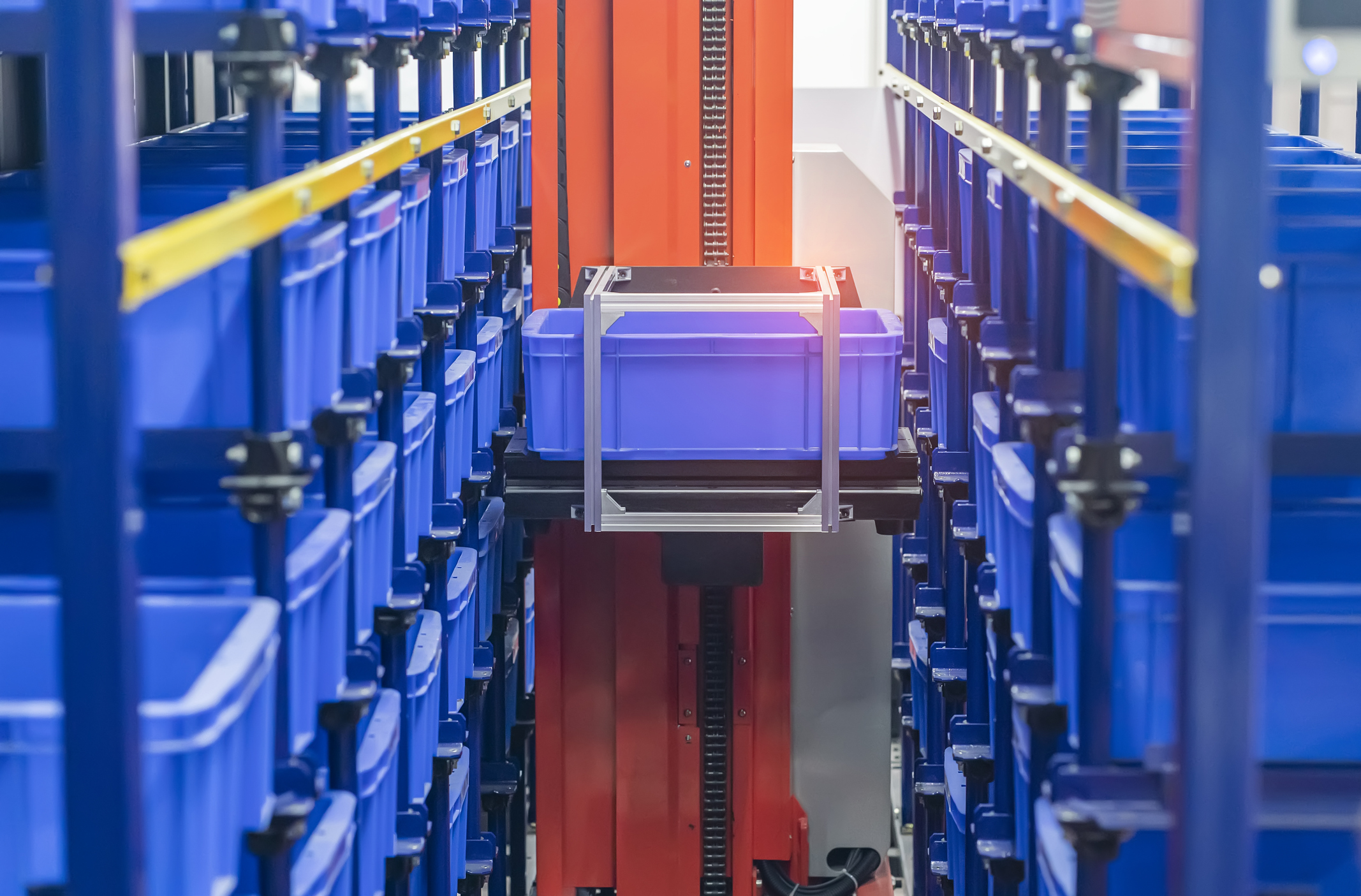 plastic boxes in the cells of the automated warehouse. Metal construction warehouse shelving