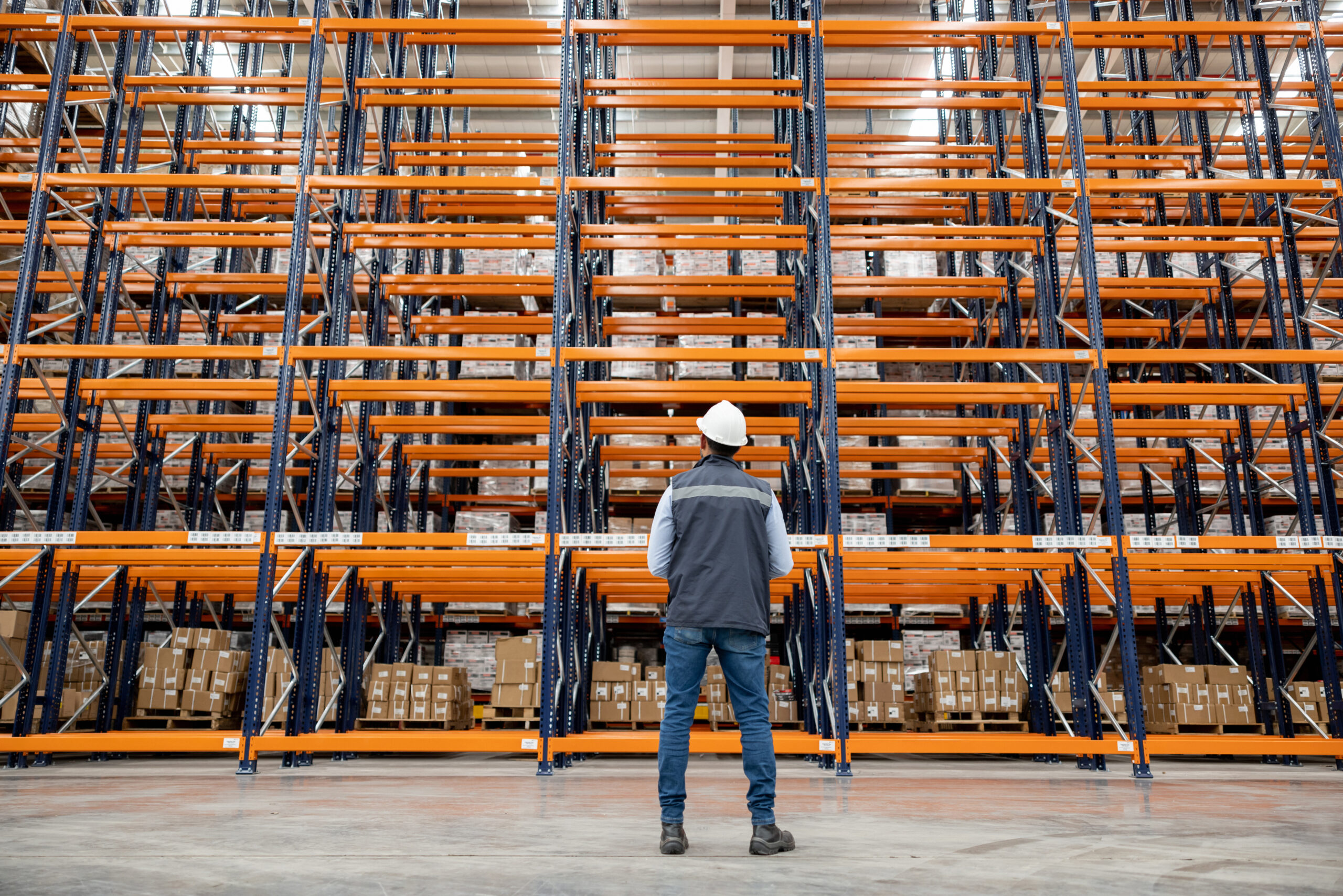 Employee supervising the operation of a distribution warehouse