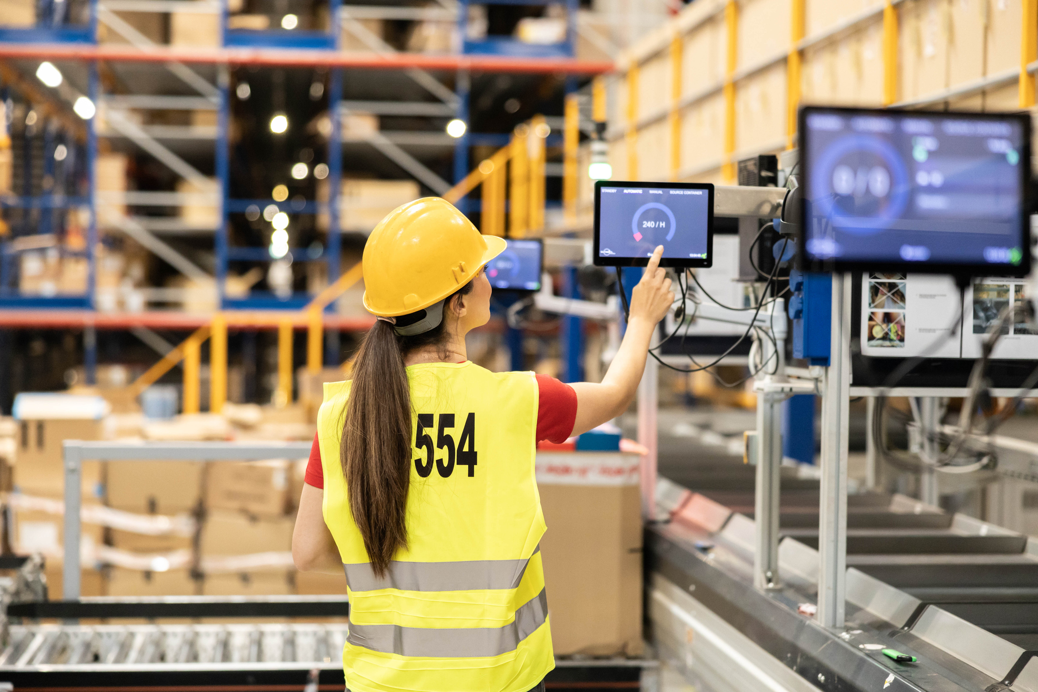 Warehouse Worker Engaging with Sorting Tech